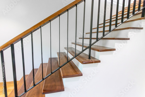 Fényképezés Side view modern wooden staircase with steel gaurd rail