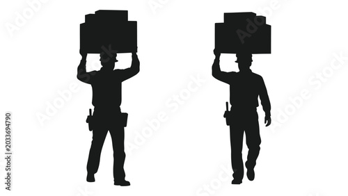 Fotografija Silhouette of two people carrying rectangular objects above their heads black an