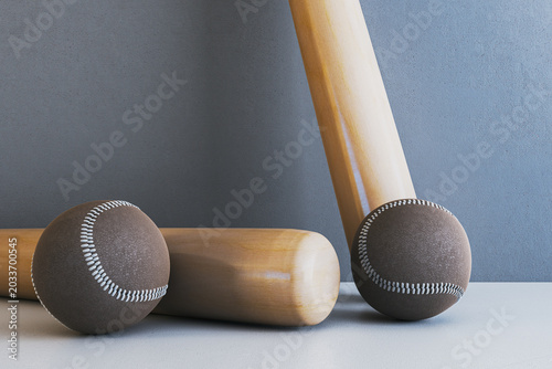 Baseball bats and balls arranged on modern minimalist background emphasizing ...