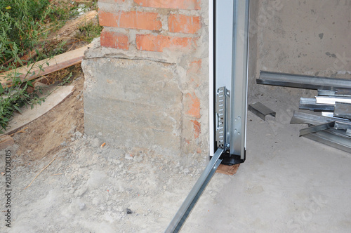 Garage Door Installation with Lift System and Metal Frame Construction