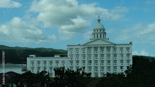 Photography Grand white building stands by calm waters
