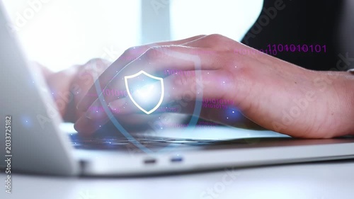 Protecting data with cybersecurity tools while using a laptop in a well-lit room during daytime.