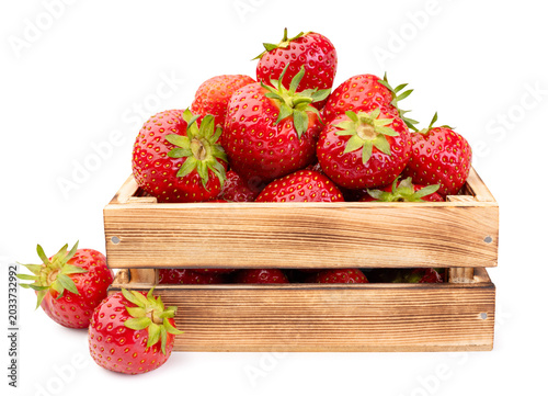 Schilderij op canvas Ripe strawberries in a wooden box on a white background. Isolated