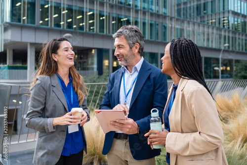 Diverse business professionals collaborating outdoors in an urban setting
