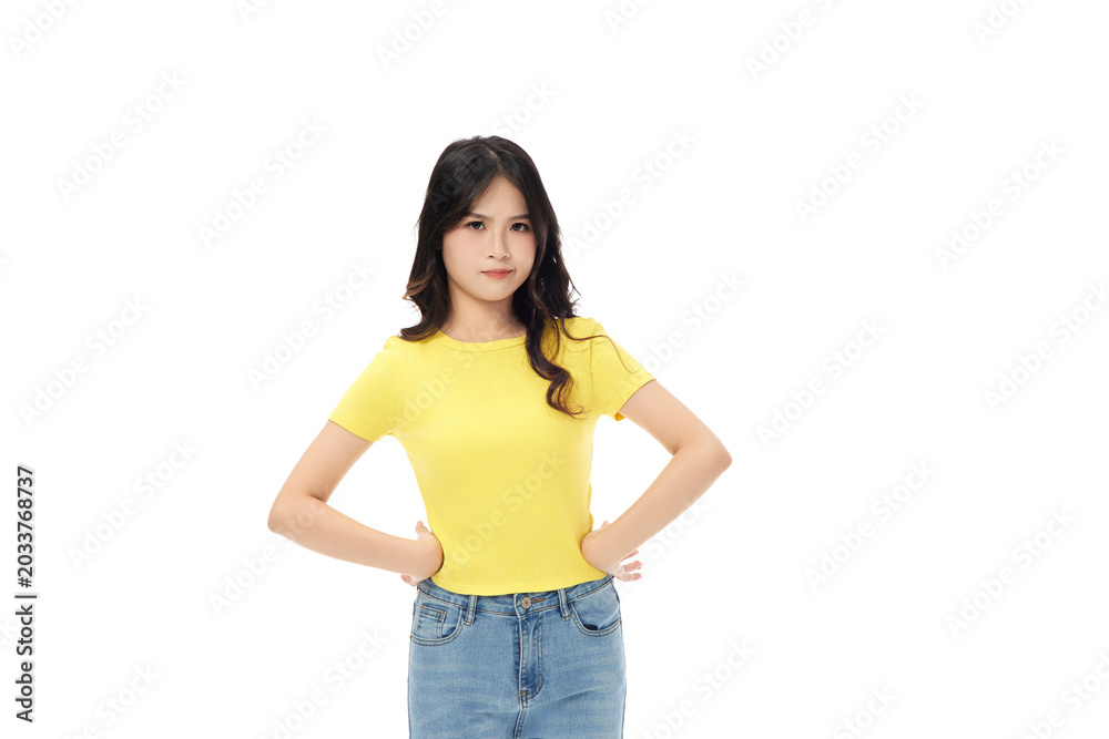 Obraz premium Confident young woman standing with hands on hips