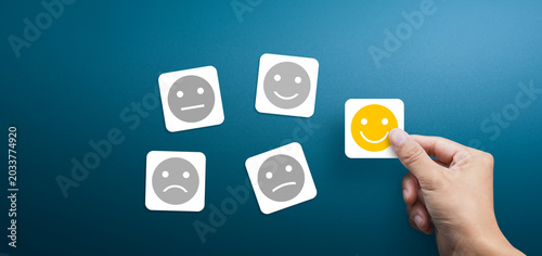 Customer service evaluation and satisfaction survey concept. client's hand picked the happy face smile face