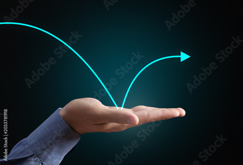 Fotografi Hand bouncing rising arrow showing business recovery and growth
