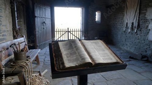 A law manuscript opened on a guardpost lectern where civic duty and sacred command intersect, overlooking a fortified gate interior with watch tools, banners, and quiet emptiness before the day begins