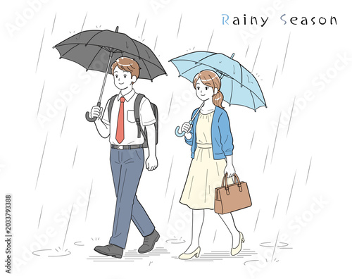 梅雨の時期に仕事に向かう男女