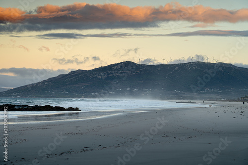 Fotografie Spanish mountainous coast with windmills and kites at sunset, Tarifa
