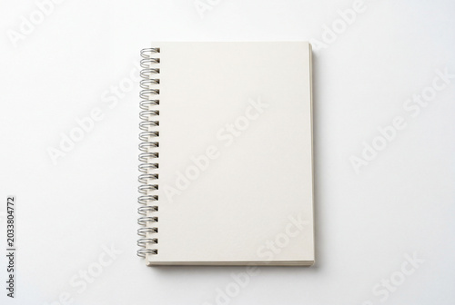 Blank spiral notebook isolated on white background, ideal for writing, notes, office stationery, education, and mockup design concepts.