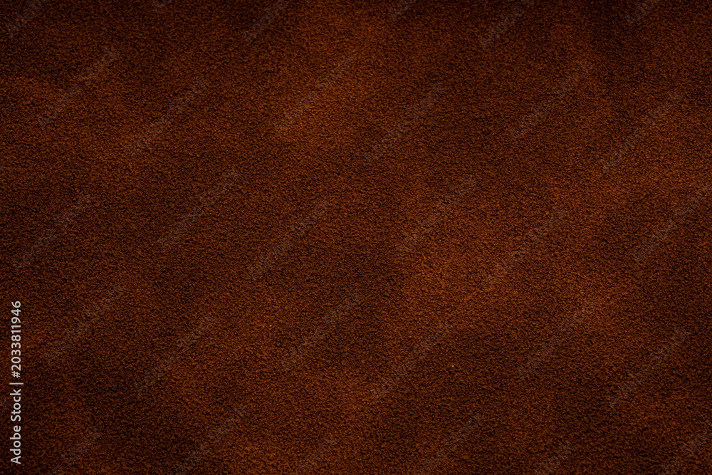 Fototapeta premium Closeup of rich brown suede texture for background use Close up of a brown suede material surface with subtle variations in tone