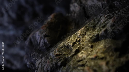 Light traveling across layered rock surface with cinematic mountain feel