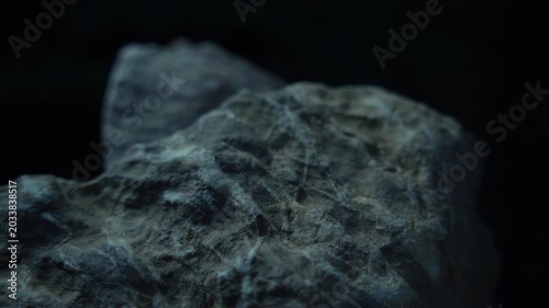 Cold toned rock surface with soft light and cinematic minimal mood