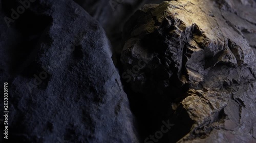 Contrasting rock surfaces with dramatic light and cinematic depth