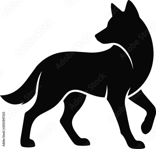 Black silhouette of a wolf standing and looking back over its shoulder.