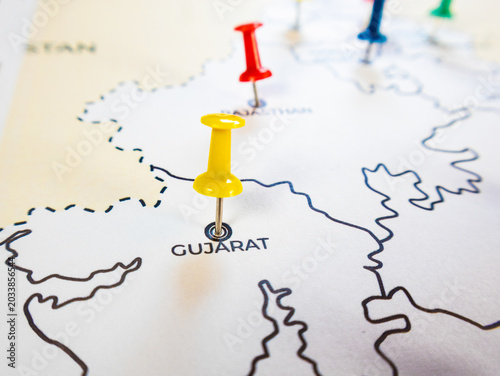 A white paper map of western India features location markers. A yellow pin marks Gujarat and a red pin marks Rajasthan, representing regional logistics, strategy targets, or travel routes.