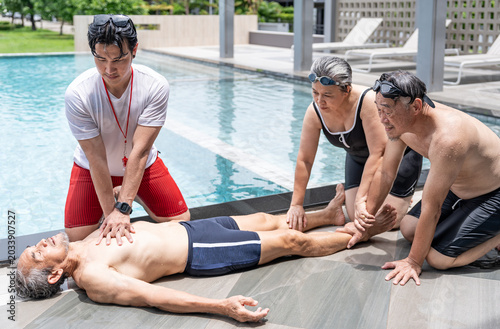 Bild auf Leinwand lifeguard performing CPR on elderly man drowns at poolside while senior friends