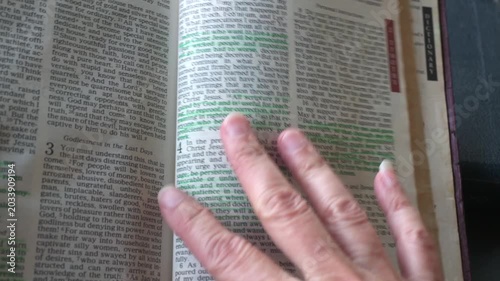April 24th 2026: Holy Bible open up to the book of 2 Timothy of the new testament, zooming into Chapter 3 verse 16 on the power of scripture. New Revised Standard Version.