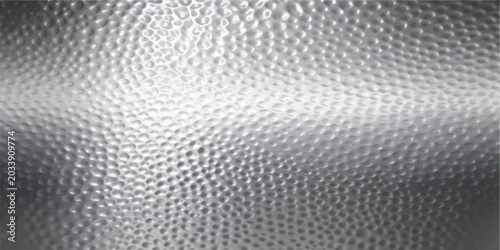 Close up of a reflective silver metal surface with a hammered texture hammered background metallic abstract industrial material backdrop reflective aluminum close up embossed geometric