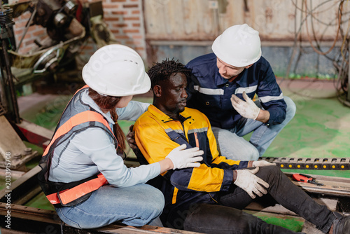 Accident worker injured on site colleague help assist, urgency workplace safety, emergency response.