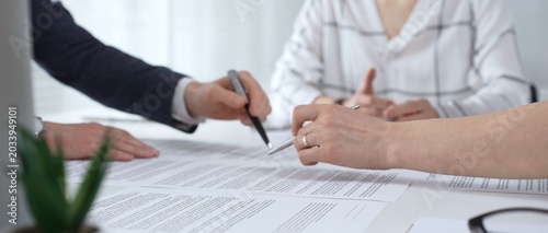 Fotografi Business professionals reviewing contracts and paperwork in a meeting, pointing