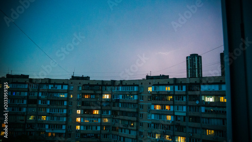 KYIV, UKRAINE - MAY 25, 2026: Lightning strike over typical Eastern European residential apartment buildings at dusk