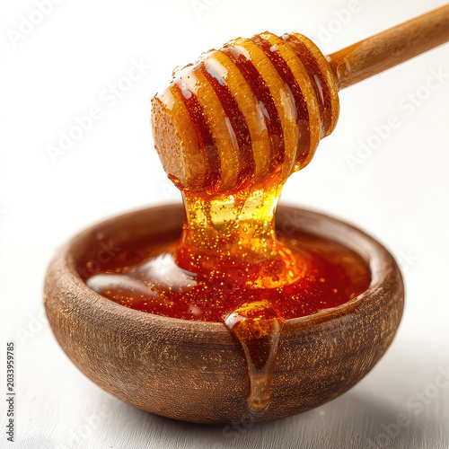 honey dripping from a wooden dipper