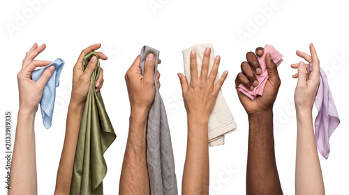 Fotografie Diverse hands holding various soft, colorful cleaning cloths and fabrics isolated on a transparent background