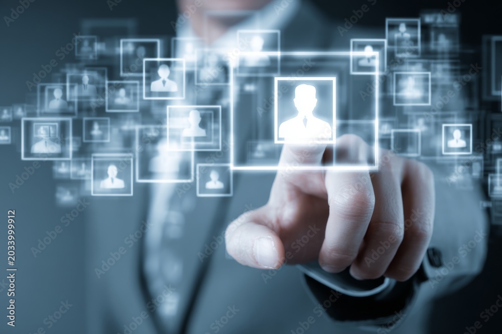 Fototapeta premium Businessman Using Digital Interface for User Identification and Selection in Futuristic Technological Environment with Displayed Profile Icons