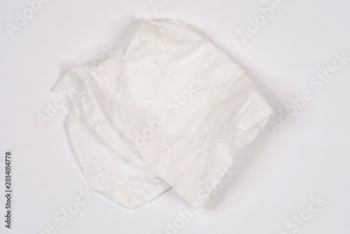 Top view of a crumpled wet wipe cleaning tissue isolated on a plain white background.