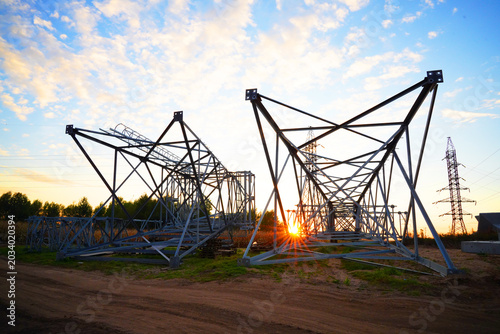 Electric tower construction. Power Tower Transmission Lines. High voltage electricity, Electrical Power Tower repair. Electric towers installation. Construction of high voltage power lines.