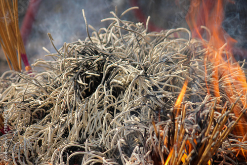 Burning Incense Pile With Ash, Smoke and Flames During Spiritual Ritual and Temple Offering
