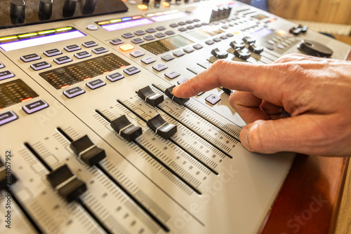 Obraz na plátně Sound engineer hand sliding fader on digital mixing console
