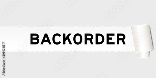 Ripped gray paper background that have word backorder under torn part