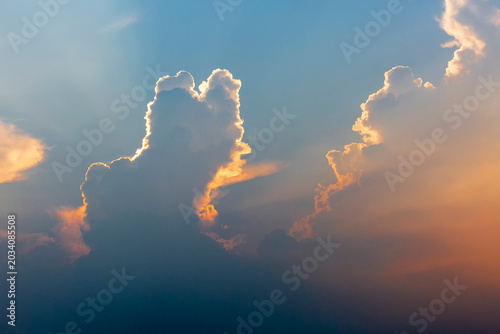 A colorful sky scene of blue, orange, yellow, and white at dusk.