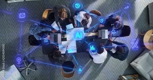 Top Down View of Diverse Business Team Gathered Around Meeting Table With Laptops and Statistical Reports. Visualization Icons Represent Connectivity, Cloud Security. Action Zoom out camera.