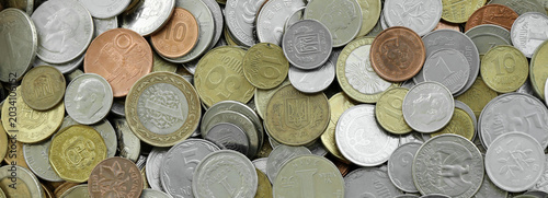 Canvas Print Heap of colorful coins from different countries, macro photography