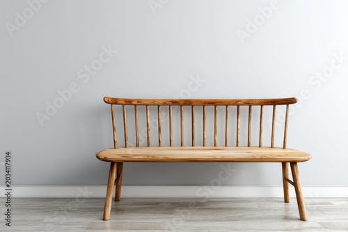 Wooden bench with spindle back against a pale wall.