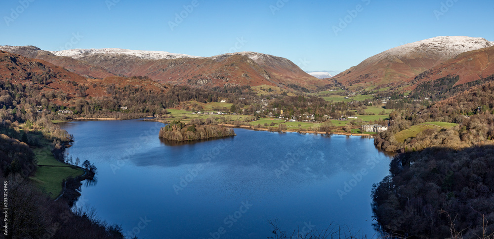 Naklejka premium Grasmere from Loughrigg Terrace looking towards Helm Crag and Rydal Fell in winter with snow on summits sunny day no people