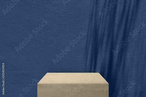 Minimalist Product Display Backdrop Features Stone Block Podium Set Against Dark Blue Concrete Wall.