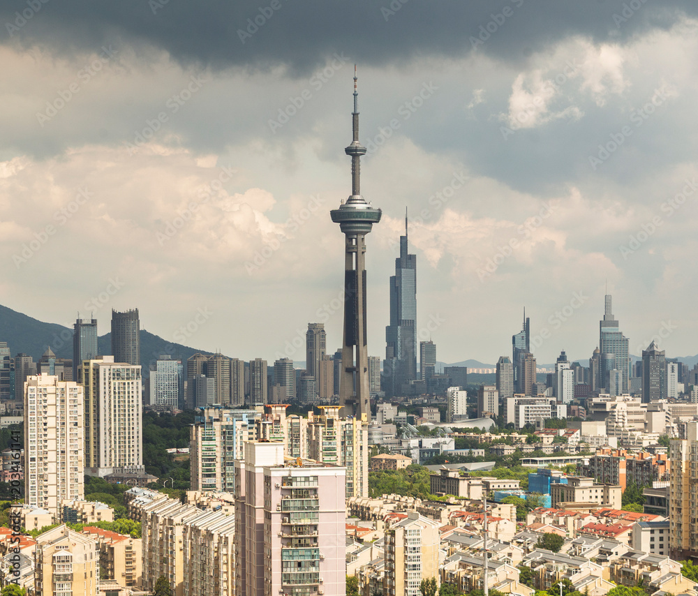 Naklejka premium Storm clouds over Nanjing skyline with modern towers and apartments