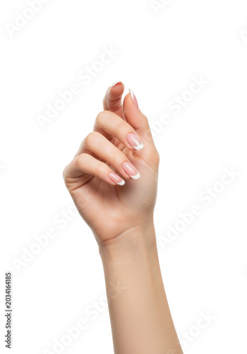 Young caucasian woman's elegant hand featuring a perfect french manicure, flawless skin texture, ultra close-up macro shot on a seamless high-key white background. concept of luxurious beauty and care