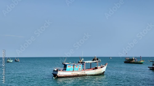 Traditional Wooden Fishing Boat Anchored in Turquoise Sea