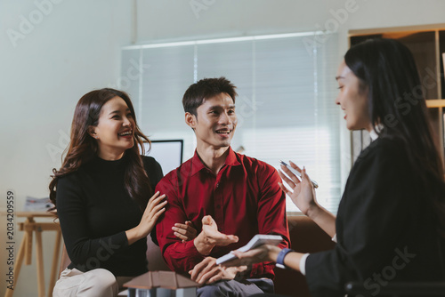 Happy couple receiving professional financial advice from a female consultant for investing in new property and personal wealth planning