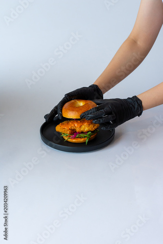 Assembling a Crispy Fried Chicken Bagel Sandwich with Spicy Sauce