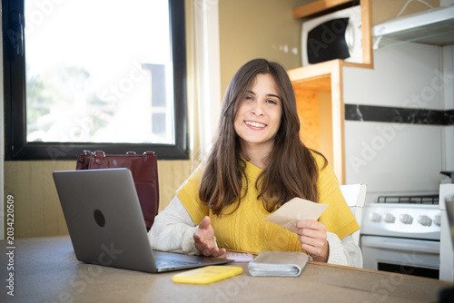 Fotografie Happy young Caucasian woman relieved after paying all her household debts