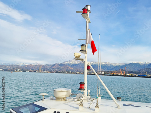 Ship with Mast and Navigation Lights near Coast