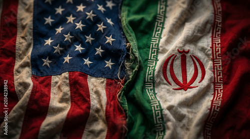 American and iranian flags sewn together in symbolic representation of complex diplomatic relations and geopolitical tensions between two nations.