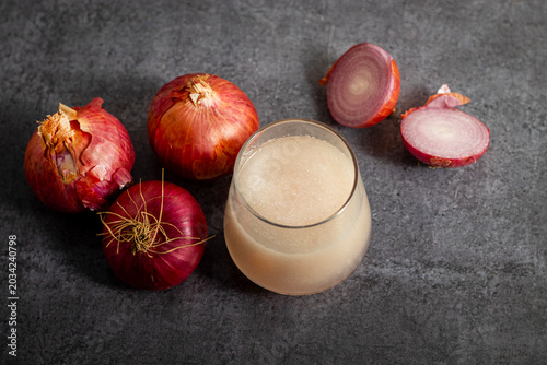 Fresh onion juice extracted from raw onions, rich in sulfur compounds, antioxidants, and nutrients, commonly used for haircare.